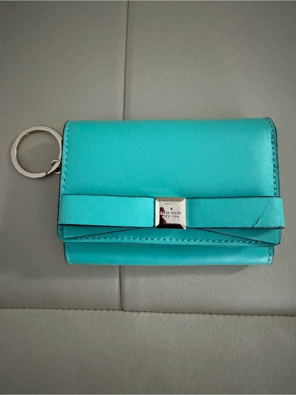 kate spade turquoise wristlet with gold logo